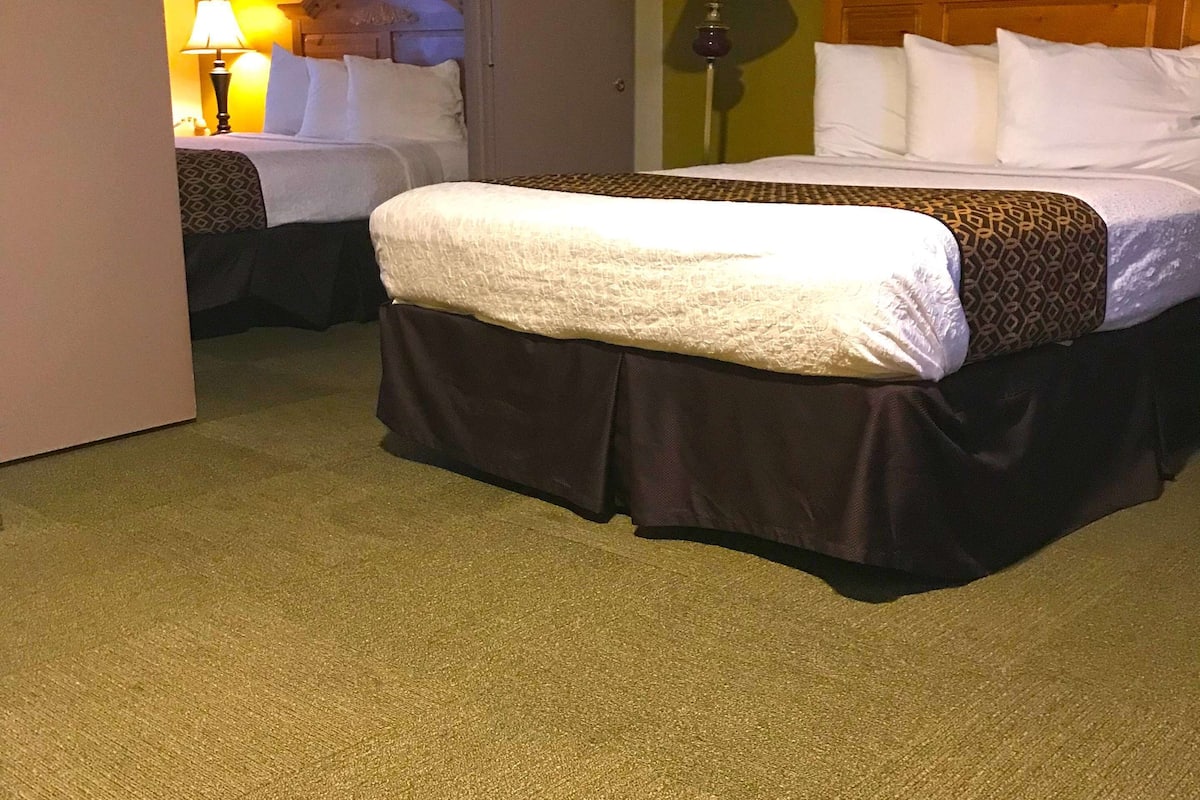 suite, 2 queen beds, non smoking | in-room safe, desk, iron/ironing board, cots/infant beds