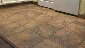 A kitchen with white cabinets, a microwave, an oven, and a refrigerator.