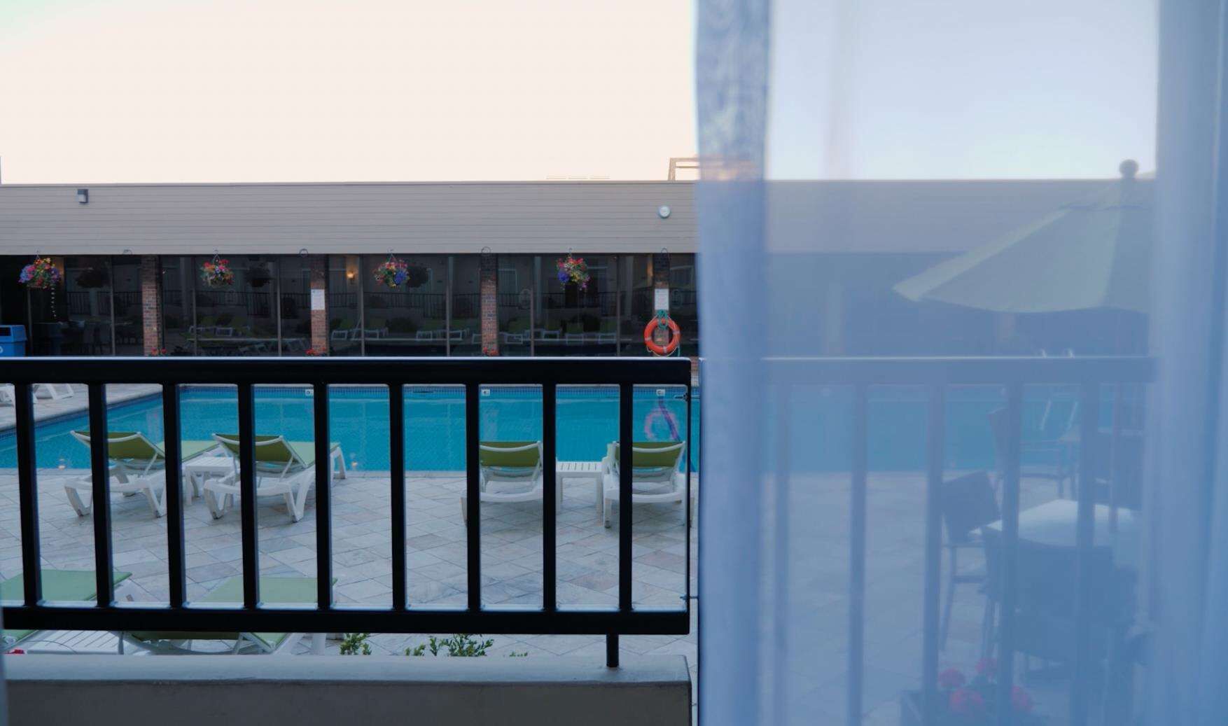 A pool area with lounge chairs and a lifebuoy.