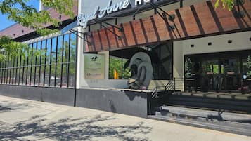 The exterior of the Royal Anne Hotel, featuring a modern facade with large windows and a prominent entrance.