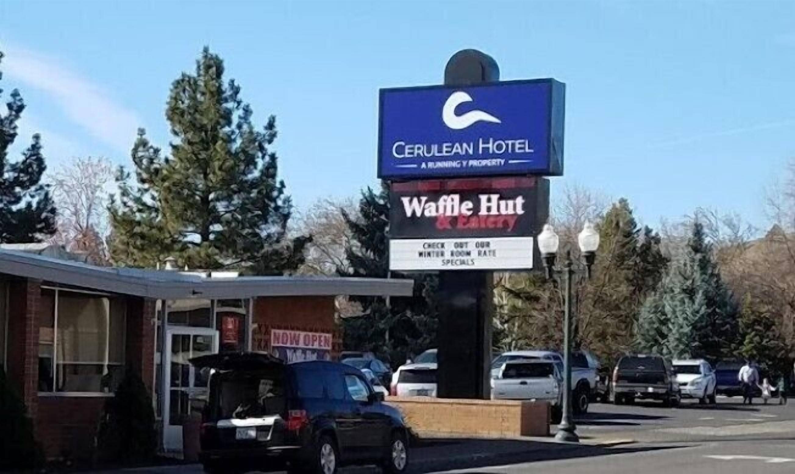Ein Schild mit der Aufschrift 'Cerulean Hotel' und 'Waffle Hut', das auf ein Restaurant hinweist.