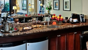 A well-equipped kitchen with a marble countertop, a coffee machine, and a variety of food items. - Crowne Plaza Portland Downtown Convention Center by IHG (Portland)