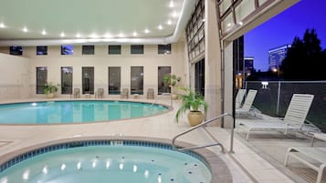 Una piscina cubierta, tumbonas