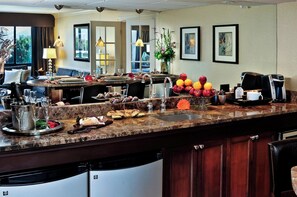 A hotel kitchen with a marble countertop, a coffee machine, and a variety of food and drink items. - Crowne Plaza Portland Downtown Convention Center by IHG (Portland)