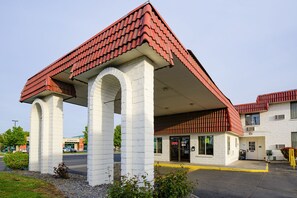 A gas station with a distinctive red roof and white pillars.