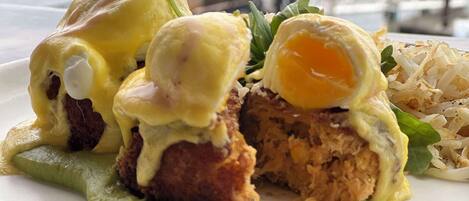 A plate of food with eggs, meat, and greens.