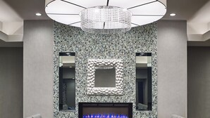 A modern living room with a fireplace, two sofas, and a patterned wall. - Waterfront Hotel Downtown Burlington (Burlington)