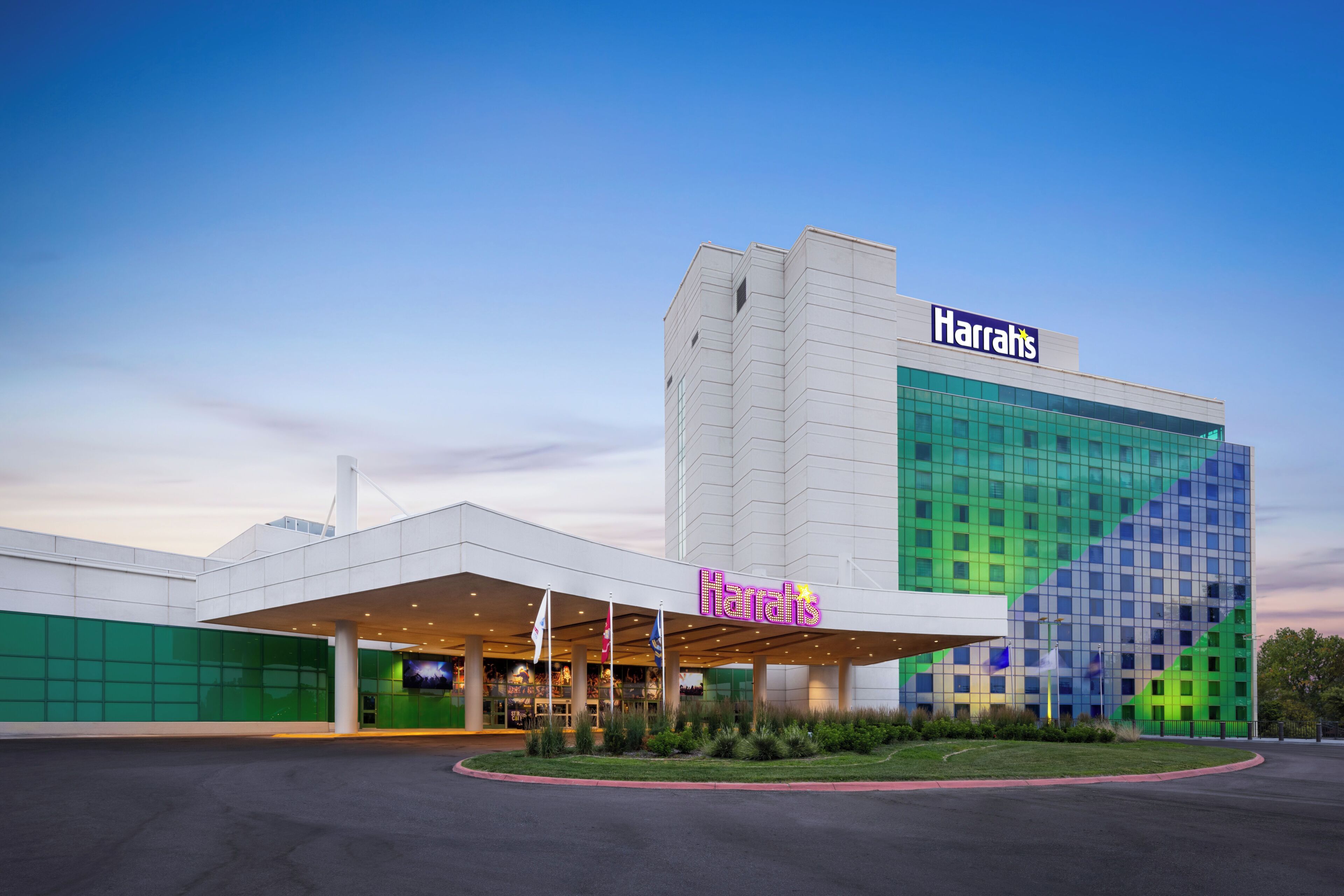 A Harrah's hotel with a modern facade, large windows, and a prominent entrance with a covered area.