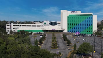 A large Harrah's casino building with a parking lot in front.
