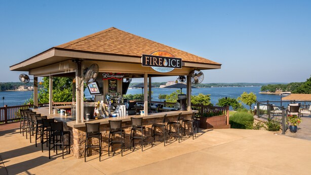 A lakeside bar named "FIRE ICE" with outdoor seating and a view of the lake. - Lodge Of Four Seasons Golf Resort, Marina & Spa (Lake Ozark)