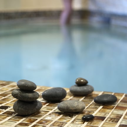 A tiled pool area with stacked stones.