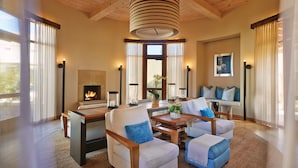 A spacious living room with a fireplace, comfortable seating, and large windows. - Four Seasons Resort Rancho Encantado Santa Fe (Santa Fe)