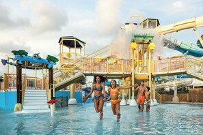 A water park with a water slide, a pool, and a play structure. - South Seas (Captiva)