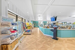 A store interior with clothing racks, shelves, and a checkout counter. - South Seas (Captiva)
