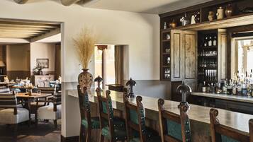 A bar area with wooden chairs and a counter.