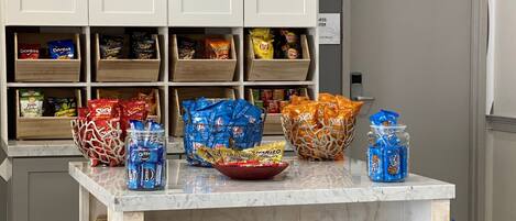 A snack display with various chips and cookies.