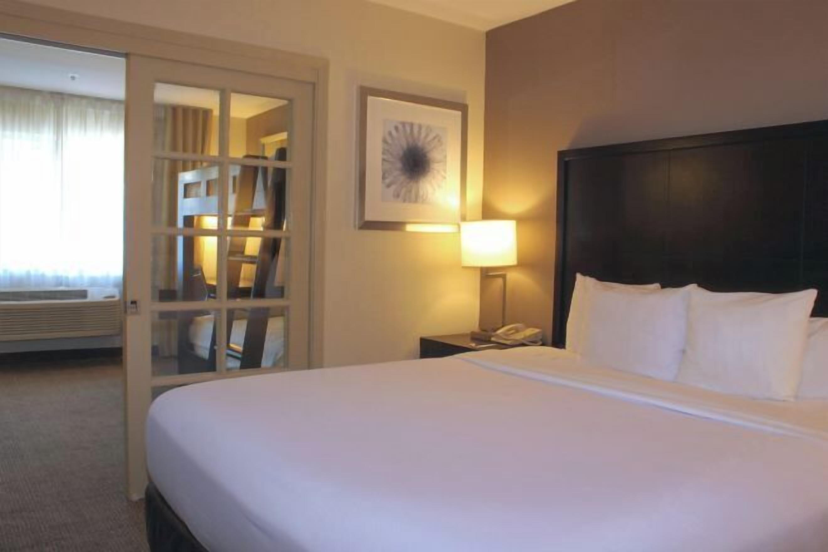 Premium bedding, desk, laptop workspace, blackout drapes