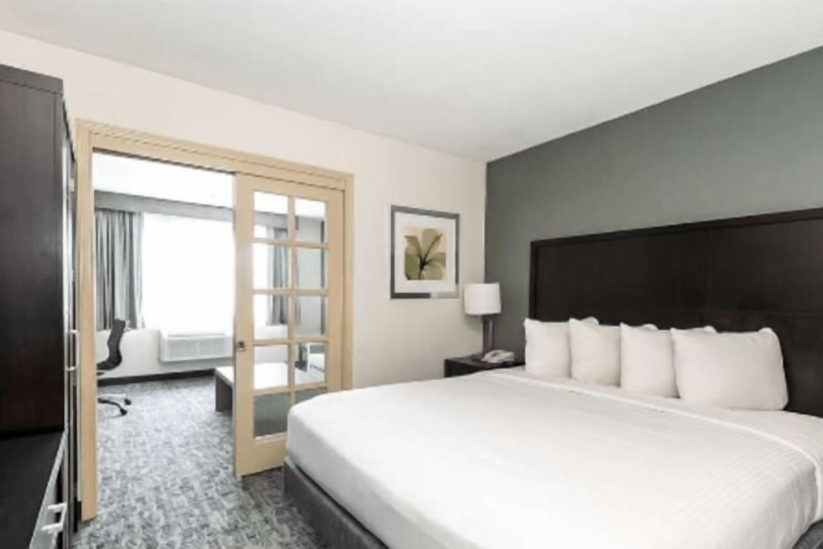 Premium bedding, desk, laptop workspace, blackout drapes