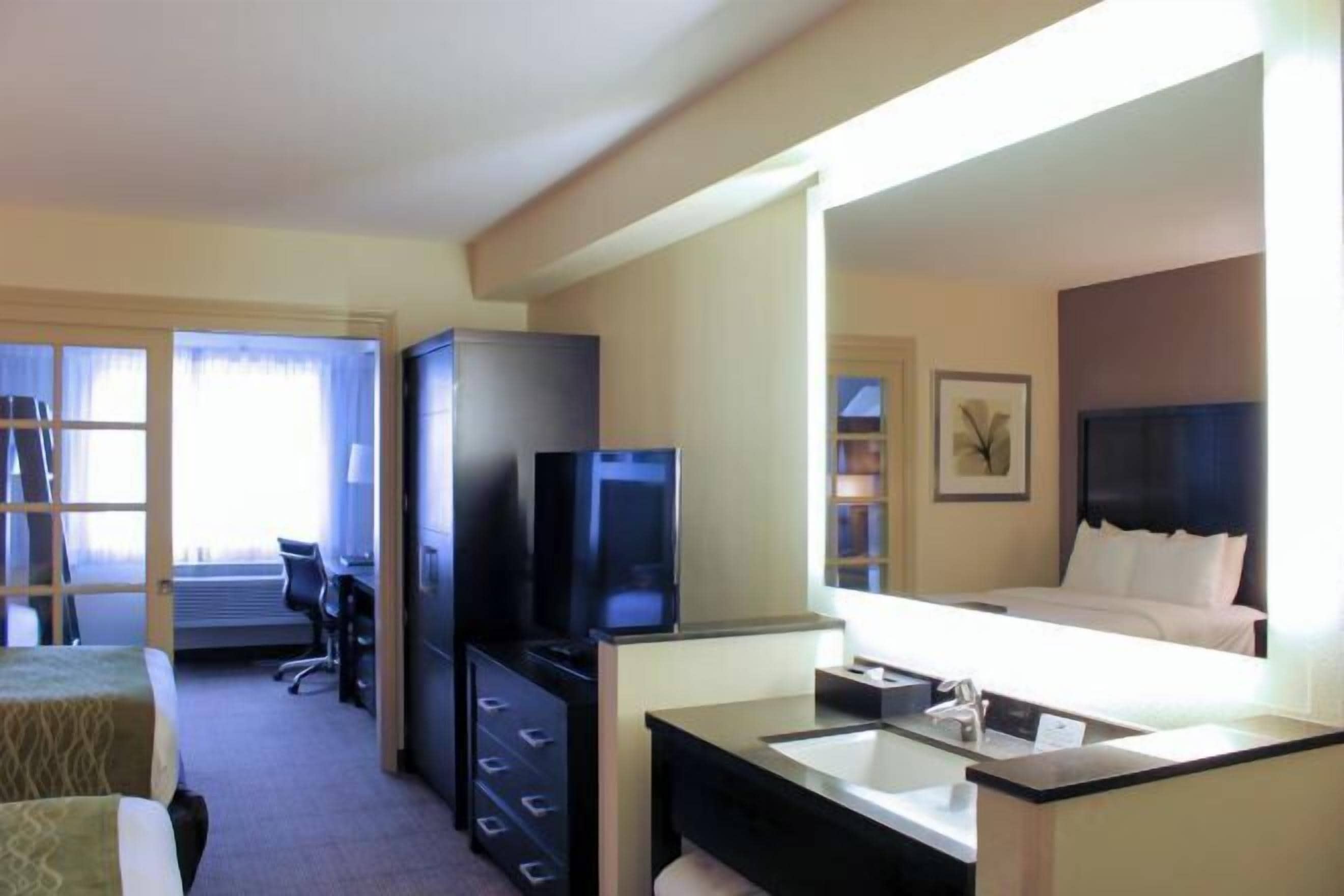 Premium bedding, desk, laptop workspace, blackout drapes