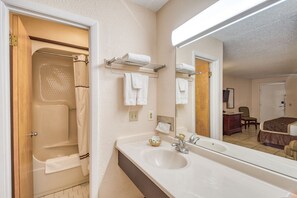 Room, 1 King Bed, Non Smoking | Bathroom | Combined shower/tub, free toiletries, hair dryer, towels