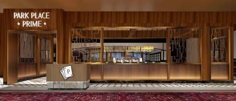 A hotel lobby with a reception desk, a sign reading "PARK PLACE PRIME", and a patterned carpet.