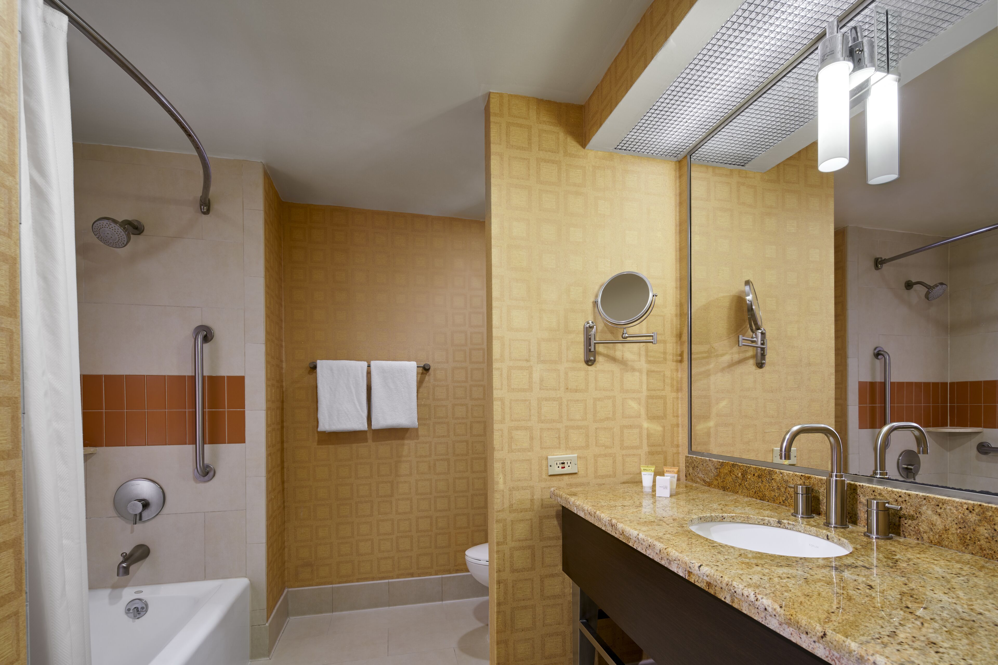 A modern bathroom with a bathtub, shower, and sink.