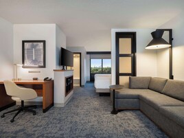 Premium bedding, desk, laptop workspace, blackout drapes