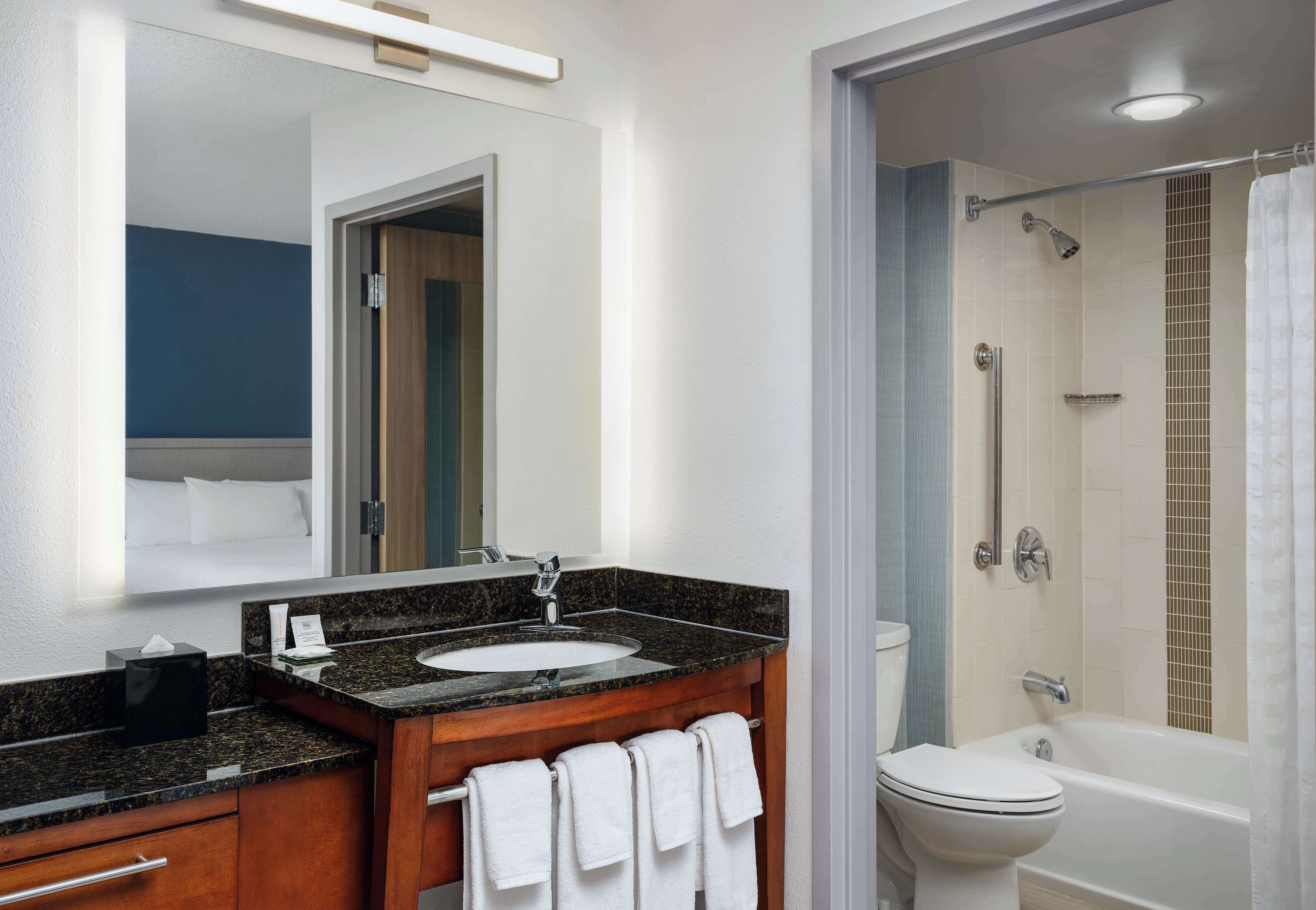 combined shower/bathtub, designer toiletries, hair dryer, towels