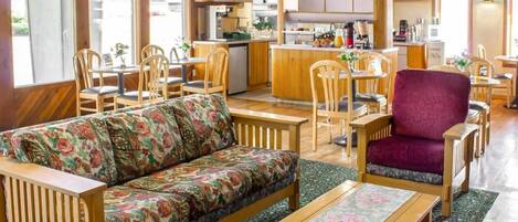 Un ambiente acogedor con sofá, sillas, una mesa de comedor y una zona de cocina.