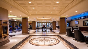 A hotel lobby with a central marble floor, columns, reception desks, and a chandelier. - Palace Station Hotel and Casino (Las Vegas)