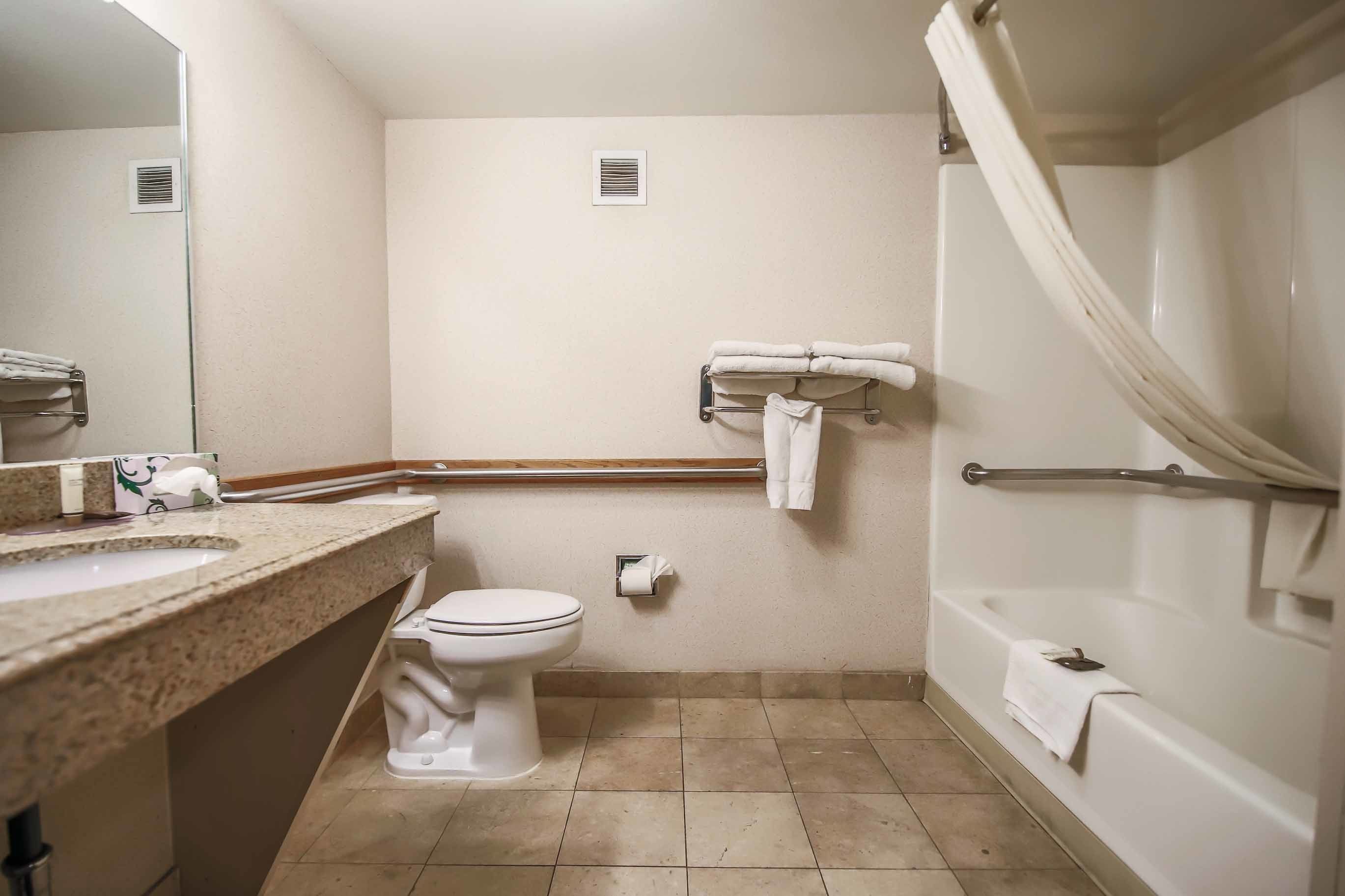 A bathroom with a sink, toilet, and bathtub.