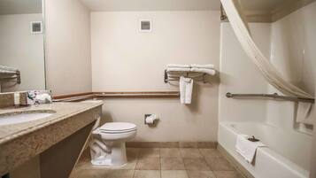 A bathroom with a sink, toilet, and bathtub.