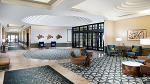 A spacious lobby with a patterned floor, comfortable seating areas, and a large entrance with glass doors. - DoubleTree by Hilton Nashua (Nashua)