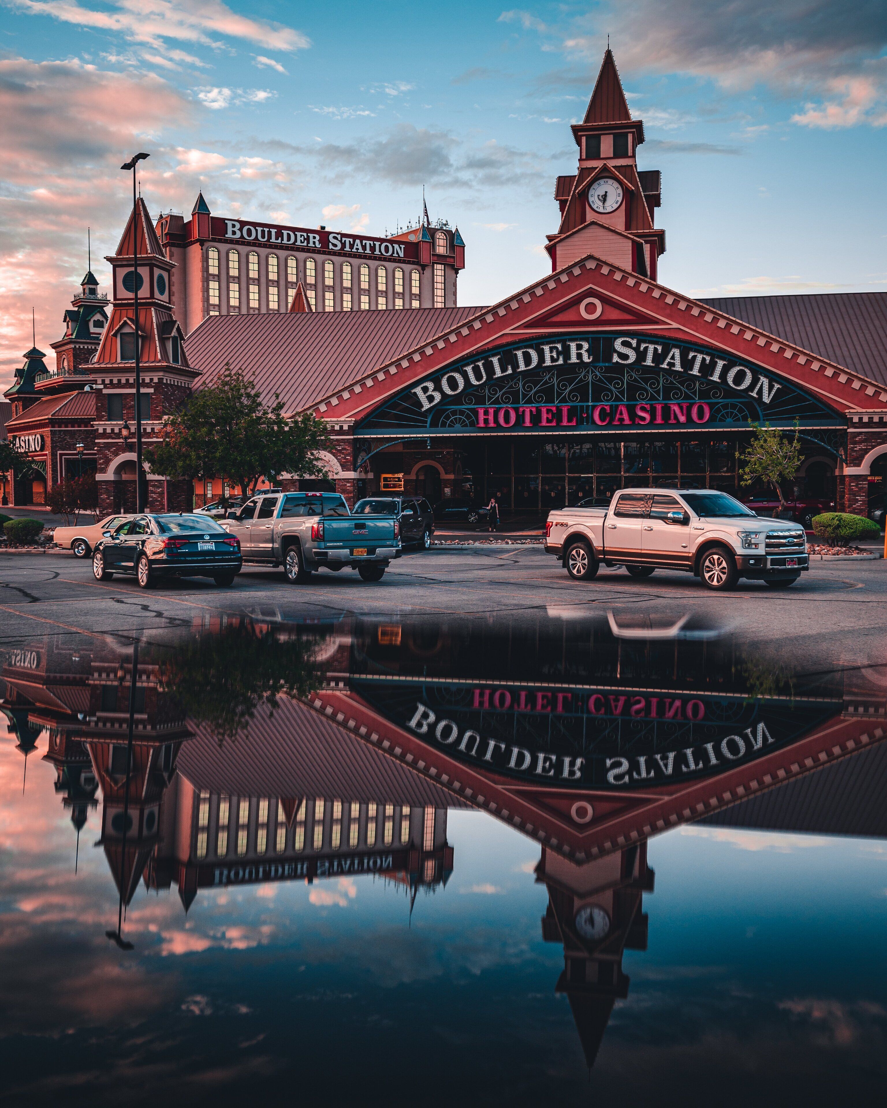 A historic building with a clock tower and a sign reading "Boulder Station Hotel Casino".