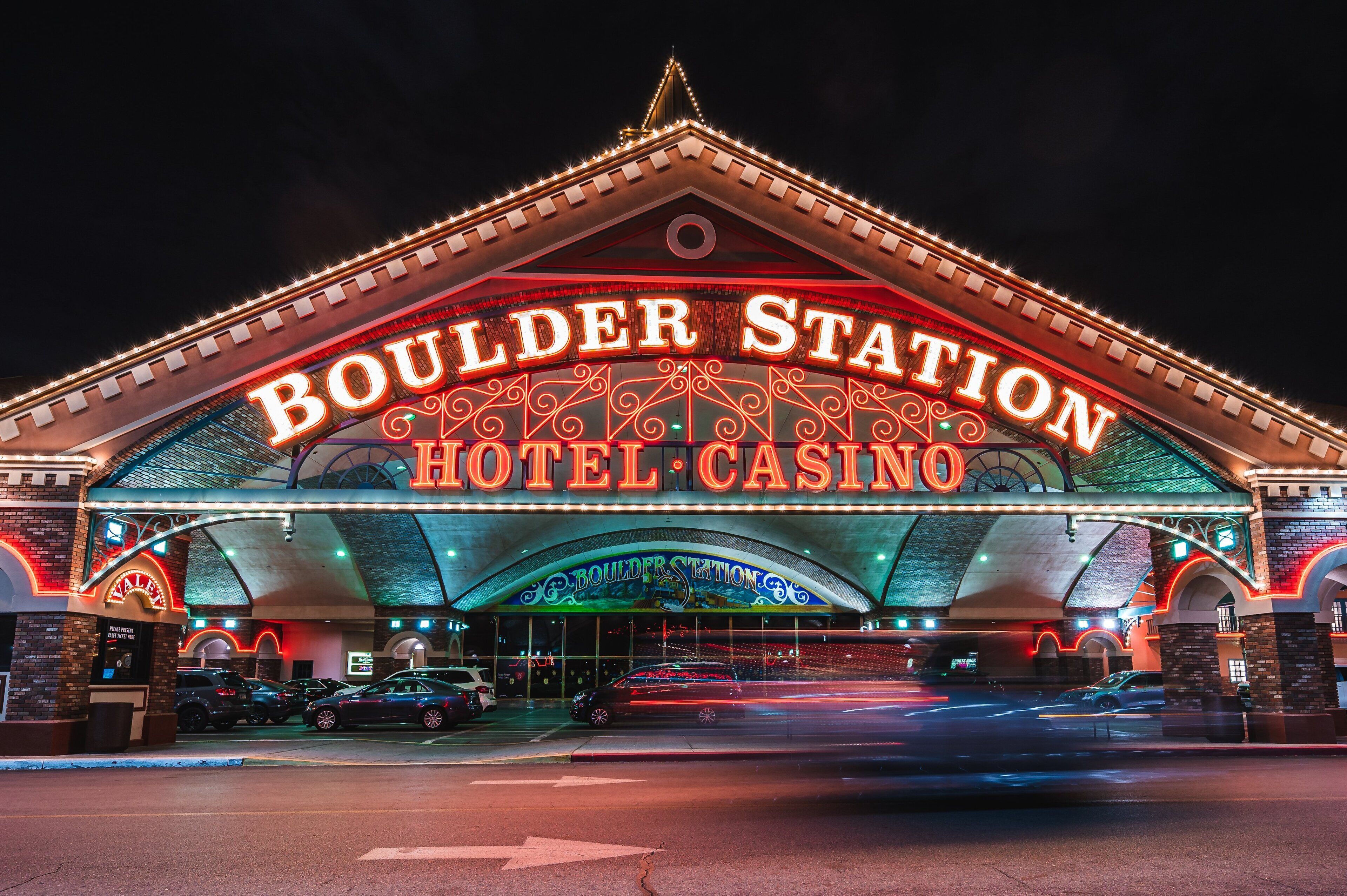 The exterior of Boulder Station Hotel & Casino with illuminated signage and a prominent archway.