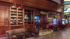 A lobby with a leather sofa, a bar area, and a sign reading "Havana Lounge".