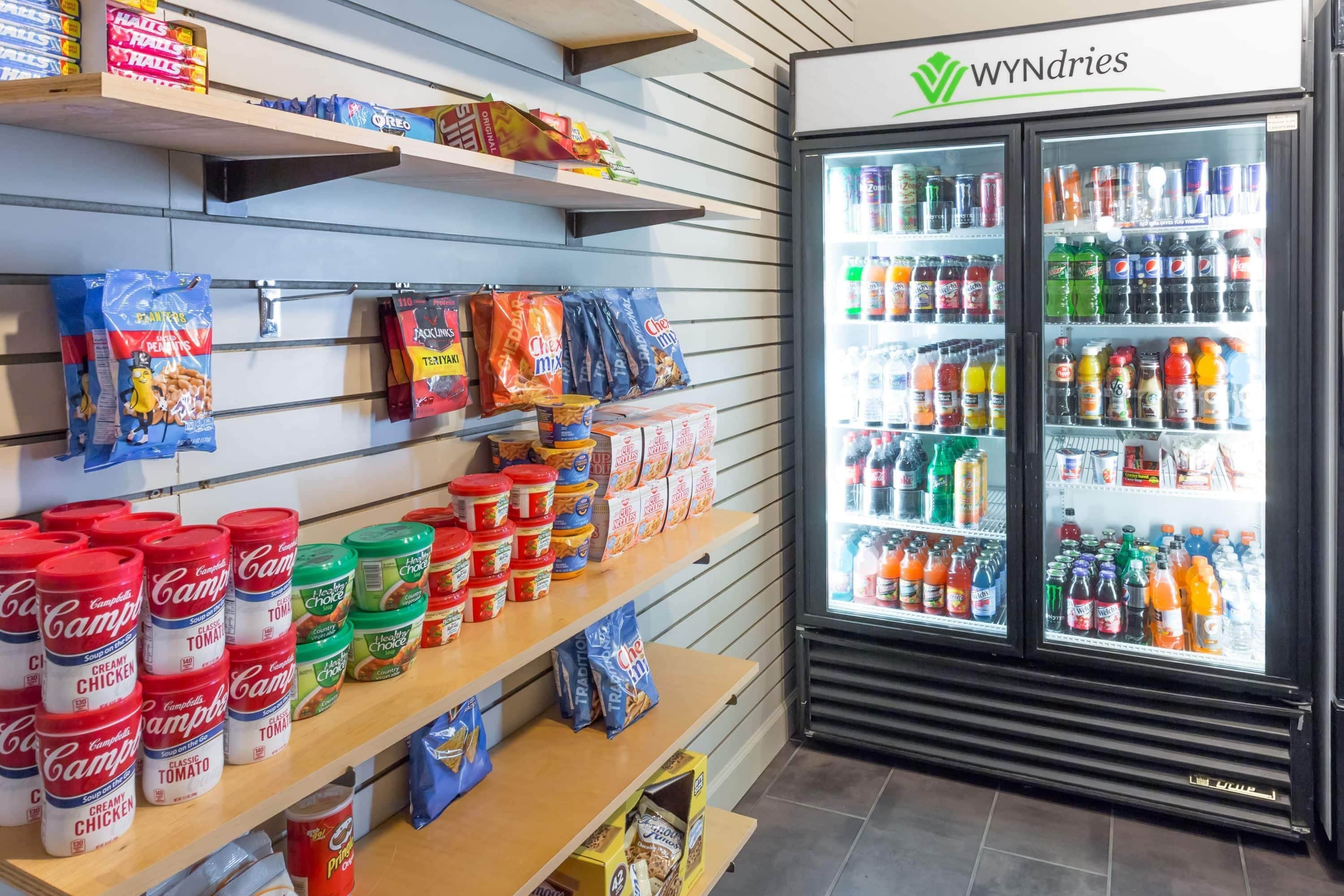 A grocery store with shelves stocked with snacks, beverages, and packaged goods.