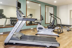 Stay active with our fully equipped fitness center featuring treadmills, elliptical trainers, and a bench.