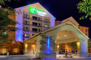 Welcome to the Holiday Inn Express & Suites, where a stone fountain greets you at the entrance.