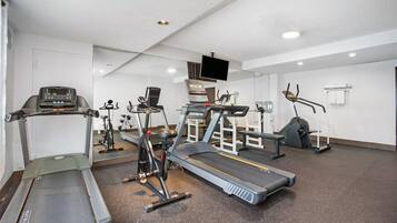 A gym with treadmills, stationary bikes, and weight machines.