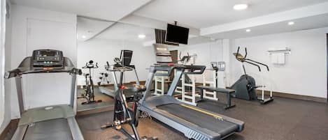 A gym with treadmills, stationary bikes, and weight machines.