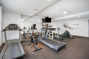 A gym with treadmills, stationary bikes, and weight machines. - Days Inn & Conference Centre by Wyndham Montreal Airport (Montreal)