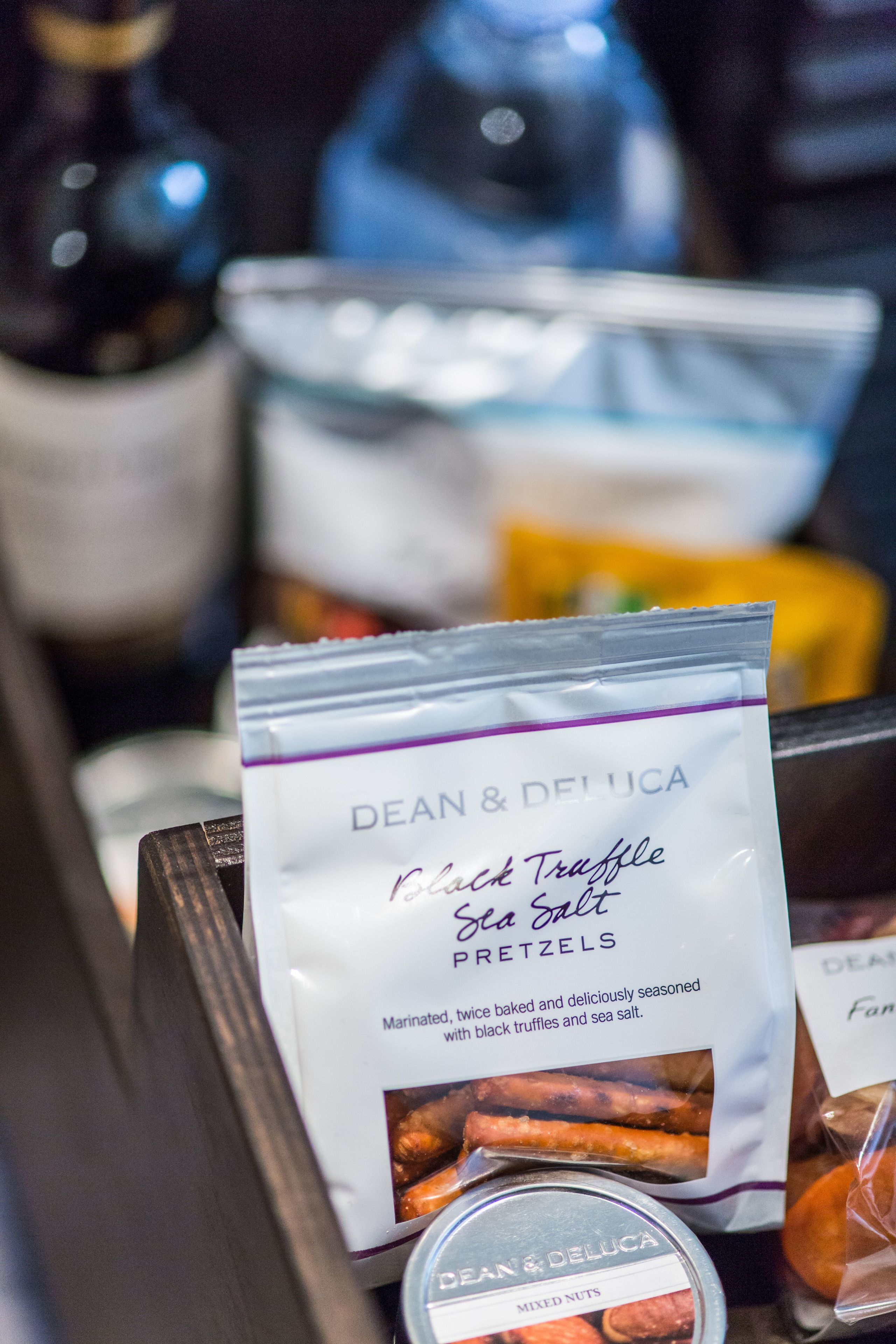 A packaged snack labeled "Dean & Deluca Black Truffle Sea Salt Pretzels" with a description of the product.