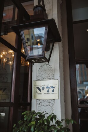 A vintage street lamp and a sign for "The Old No. 77 Hotel & Chandelier" on a building facade. - The Old No. 77 Hotel & Chandlery (New Orleans)