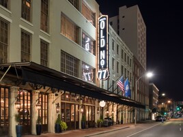 A hotel with a marquee sign reading "Old No. 77" and a classic architectural style.