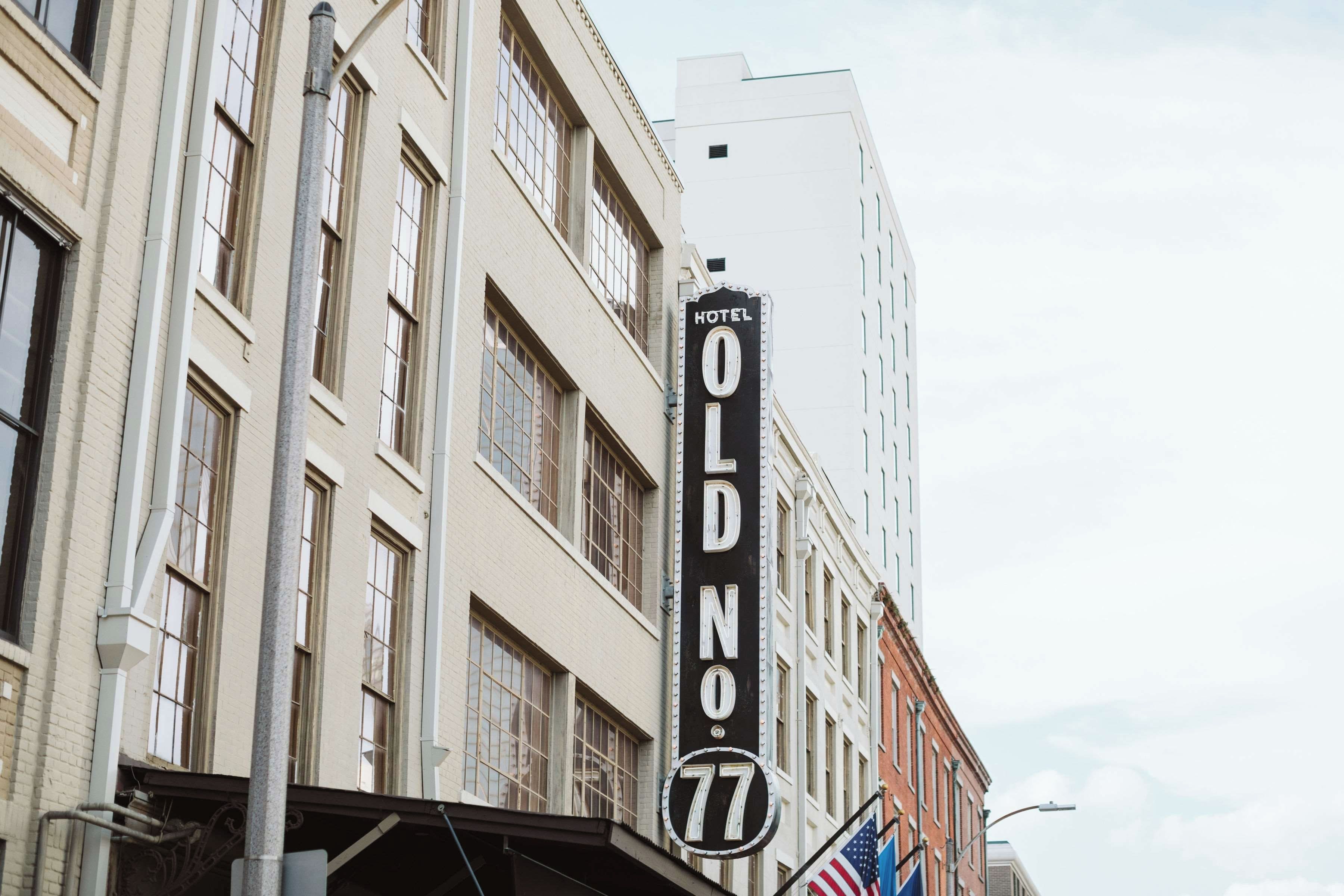 A hotel sign with the name 'Old No. 77' and a number '77' below it.