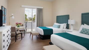 A hotel room with two beds, a desk, a chair, a dresser, and a balcony with curtains.
