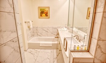Separate tub and shower, free toiletries, hair dryer, towels at The Capri Inn