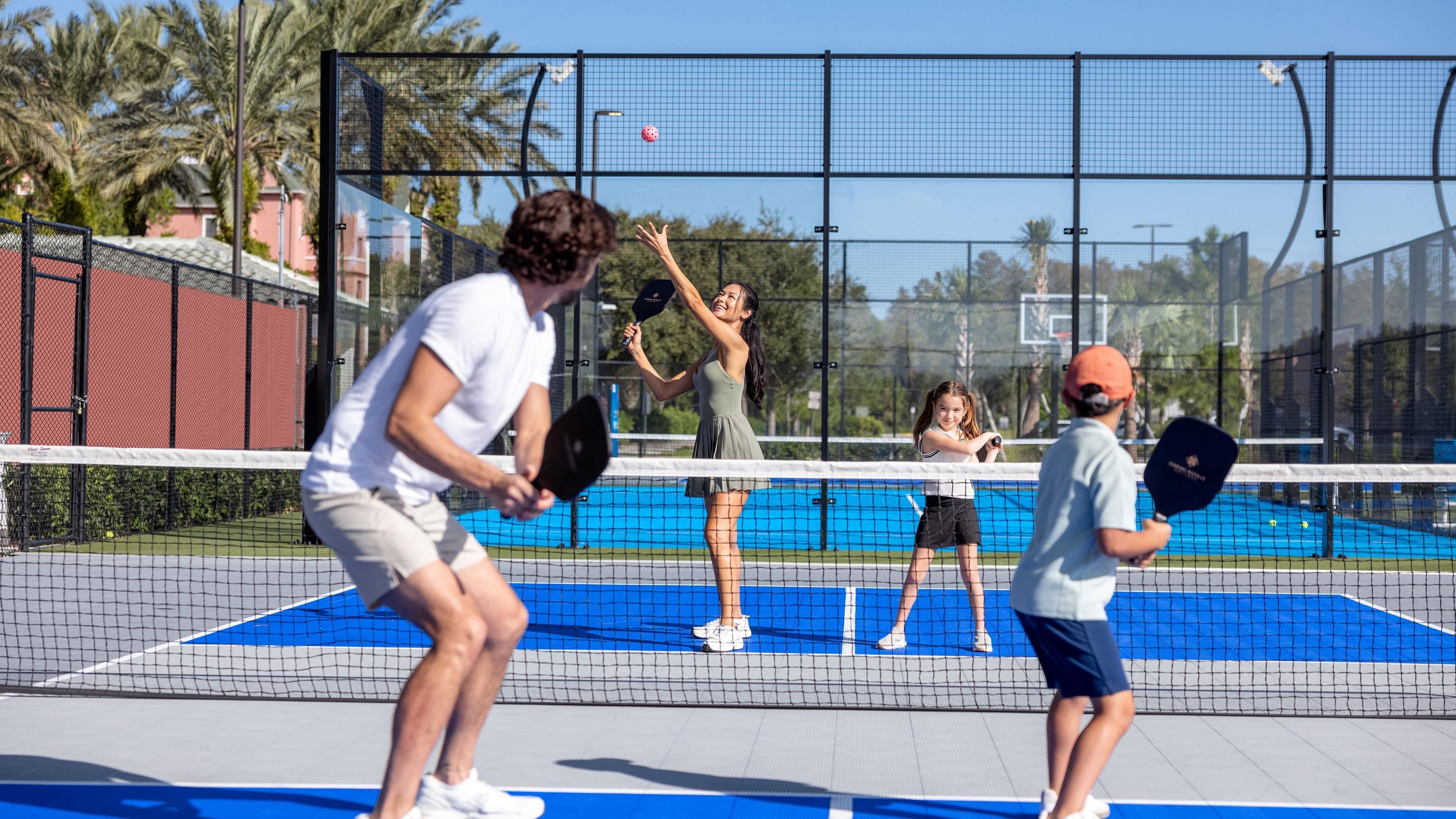 A tennis court with players and a net.