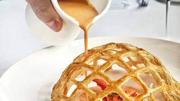 A waffle with strawberries on a plate.